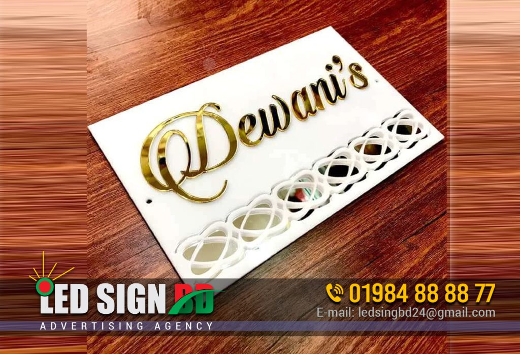 Custom Acrylic Glass Wooden Nameplate Design Dhaka Leave a Comment / Acrylic Nameplate Design, Glass Nameplate, Wooden Nameplate / By LedSjgnBdltd Designer name plate for home. It is the first thing a visitor looks at while coming to your place. It is the very first impression on your guest. So it must not just be impressive, but should also tell a small story. Name Plate Signs Price in Dhaka Bangladesh | Mirpur Dhaka Bangladesh. Name Plate Signs Price in Dhaka Bangladesh name plate price in BD. Acrylic Letter and Glass Name Plate Design BD Name plate shop near Mirpur Gulshan Banagni. Acrylic, Acp, Wood, Glass nameplate And Signboard | Dhaka. Shop name plate price BD. Acrylic Name Plate Signage. Desk Name Plate with Logo Graduation Gift Wood. Name Plate Holders Manufacturer from Agra. Custom Acrylic Glass Wooden Nameplate Design Dhaka. Custom Acrylic Glass Wooden Nameplate Design Dhaka ame Plate Bangladesh | acrylic nails dhaka acrylic design It would be a story that you would like anyone coming in to read. It would be a story which would give a smile to anyone passing by. For example, one of our customers got the following written below their name – “Come as friends, Leave as Family”. This creative quote for a name plate tells a lot about the host’s nature. It would instantly make the person coming in feel invited. Custom Acrylic Glass Wooden Nameplate Design Dhaka. Bringing to you a range of exquisite designer name plates made in acrylic, wood and metal. Now, you can sit in the comfort of your home/office and select a describes your identity the best. After all, this is what a designer name plate is all about. name plate bike name plate design Bangladesh Acrylic name plates Name plate is a product that you do not change often. Hence the material and build quality of a door name plate should be rugged. Acrylic gives your name board the shine of glass while being strong. This makes it a great choice for house name plates. It is a material that is used in outdoor signage. Being weatherproof, outdoor application for an acrylic name plate is feasible. They give you the best quality of designs for a long time. It is waterproof, easy to clean, and perfectly fit material for an available designer name plate. We at Zoci Voci, give you not only the best quality acrylic name plates but also an aesthetic one. We have a range of LED acrylic name plates that will light up your front door. LED Name plates don’t only serve the purpose of aesthetic superiority, but also adds a spiritual value. Light is synonymous with positivity, so who doesn’t want to light up their home sweet home? house name plate design in Bangladesh name plate design bd Wooden name plates Nothing is as classic and timeless as wood. A wooden engraved name plate adds an absolute royalty to your door. Engraving into raw woods have conventionally defined name plates for many households. May it be flats, bungalows or apartments, the raw feel of wood with engraving atop, makes them look naturally appealing. But raw blocks being thick, they can not be laser cut at a good cost. For that, MDF – a processed form of wood can be used. Such a laser-cut wooden name plate combined with acrylic letters gives a lot of liberty to design. There are many shapes and geometries possible with vinyl layers used for giving the same natural feel. Such wooden name plates that are laser cut with acrylic letters on it gives out the perfect type of conventional creativity. name plate design Bangladesh Stainless steel name plates If metal entices you, give your abode a rugged look. While our engraved steel name plates offer some unique design elements, our LED steel-cut name plates bring the best of both worlds – the beauty of backlit and the strong impact steel flaunts. Steel name plate for home has been in trend for ages. But the contrast between engraved metal and the silvery shine is perennially beautiful. But if you are comparing wood, acrylic, or stainless steel name plates, it will be a good idea to go through this article. Name plates materials – which are better and why? Stylish Name Plates Do you want to go different from the conventional name plates? Do you want to show your visitors the maximum creativity that your home radiates? Zoci Voci has a perfect range of designer name plates for you. These stylish name plates show the out of the box creativity that you have. You have a beautiful range of name plates like the backlit monogram and also radium name plates. name plate design for home Bangladesh Metal Name Plates A metal name plate gives your door a more captivating look. Zoci Voci offers a range of metal name plates with beautiful designs and fonts engraved and will surely make your front door look extravagant. LED name plates Light by its nature attracts the eye. The aesthetic of any graphic gets enhanced when there is a light coming from within. Naturally a name plate with light would look better than a regular non-lit design. Hence the first reason to buy would be aesthetic superiority. But that would not be it. Light not just looks good to the eye, but it also adds a spiritual value to the signboard. At night, the light radiating of your name plate would give that soft fall off which may be required on the dark street. Also with purity and goodness being synonymous with it, light overall adds a positive impact to the home décor. You can check out this video to get an idea about the beautiful impact a LED name plate can have. If LED name plates intrigue you, and you wish to know more about them, here is an article which covers everything you need to know before buying led name plates Best Signboard Making Company in Dhaka Bangladesh Water-proof name plates While designing any product, its longevity has always been our prime focus. Hence majorly all our signboard designs are weatherproof. Even the ones with light inside have been made with acrylic which is a completely waterproof body. Name plates according to Vastu Shastra Our Indian tradition believes every element to have a significance. If you wish to know the age-old science before picking a name plate according to the direction of your door, here is a good read which throws light on name plates according to Vastu Shastra