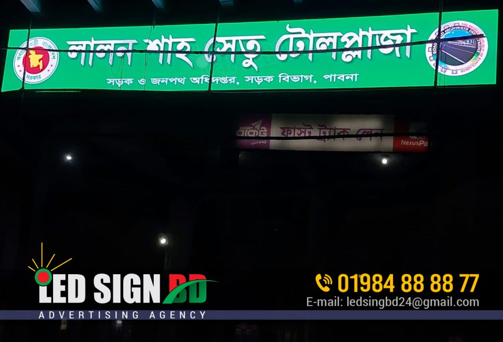 Toll & Bridge Led Signboard Billboard Agency in Bangladesh Leave a Comment / LED Acrylic Sign / By LED Sign Led Sign BD Ltd is a renowned agency specializing in the design, production, and installation of toll led signboards and bridge signboard billboards in Bangladesh. With our commitment to excellence and innovation, we have established ourselves as a trusted partner for businesses and organizations across the country. Toll & Bridge Led Signboard Billboard Agency in Bangladesh. Toll & Bridge Led Signboard Billboard Agency in Bangladesh At Led Sign BD Ltd, we understand the significance of effective signage in capturing attention and delivering messages. Our team of skilled professionals combines creativity and technical expertise to create captivating and visually stunning toll led signboards and bridge signboard billboards that make a lasting impression on your target audience. We pride ourselves on using state-of-the-art technology and high-quality materials to ensure the durability and longevity of our signboards. Whether you need toll led signboards for expressways, highways, or toll booths, or bridge signboard billboards for promoting events, products, or services, we have the expertise to meet your specific requirements. Toll & Bridge Led Signboard Billboard Agency in Bangladesh. বাংলাদেশে টোল অ্যান্ড ব্রিজ লেড সাইনবোর্ড বিলবোর্ড এজেন্সি When you choose Led Sign BD Ltd, you benefit from our comprehensive services. Our dedicated team works closely with you from the initial concept and design stage to the final installation. Ensuring that every aspect of your project is executed seamlessly. We take into account your brand identity, messaging, and location. To create signboards that effectively communicate your message and attract attention. Customer satisfaction is our top priority at Led Sign BD Ltd. We strive to deliver exceptional results that exceed your expectations. Our team is responsive and attentive to your needs, providing personalized solutions and timely support throughout the entire process. So, whether you are a government agency, private enterprise. Advertising firm looking for toll led signboards or bridge signboard billboards in Bangladesh. Led Sign BD Ltd is the agency you can rely on. Contact us today to discuss your signage needs and let us help you make a powerful statement with our expertly crafted signboards.