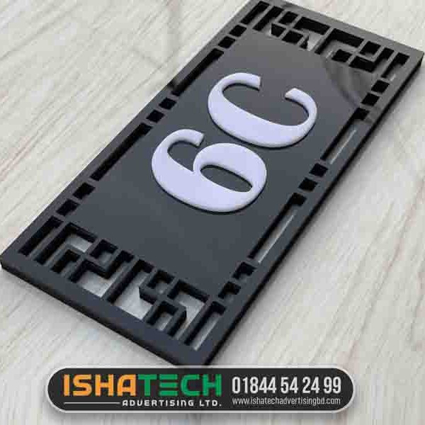 A black and white acrylic house number nameplate
